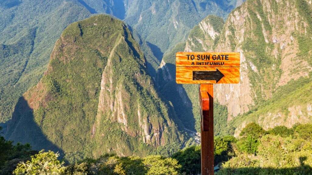 The Sun Gate overlooking Machu Picchu surrounded by majestic green mountains in the Peruvian Andes